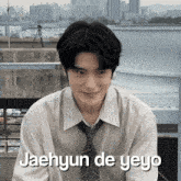 a man in a striped shirt and tie with the words jaehyun de yeyo
