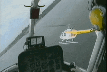 a yellow and white helicopter with the letters ec on the tail