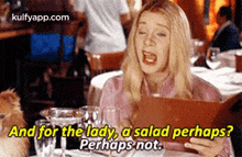 a woman is sitting at a table in a restaurant looking at a menu and talking about a salad .
