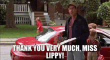 a man is standing in front of a red car and holding a piece of paper that says thank you very much miss lippy !