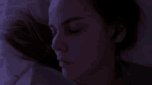 a close up of a woman 's face in a dark room
