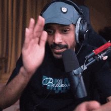a man wearing headphones and a shirt that says brilhar