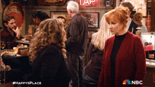 a nbc ad for happy 's place shows two women talking in a bar
