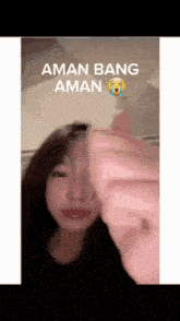 a woman is crying while holding a piece of paper in her hand .