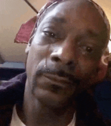 snoop dogg is crying while looking at the camera .