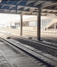 a train track going under a bridge with a sign that says ' a ' on it