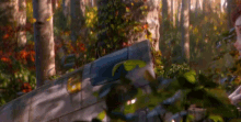 a cartoon girl is sitting in a canoe in the woods with a purple backpack .