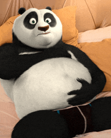 a cartoon panda bear is laying on a bed with his arms around his stomach