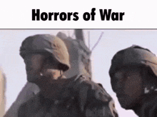 a couple of soldiers standing next to each other in a field .