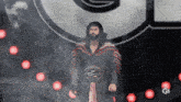 a wrestler with a belt that says ' grand ' on it