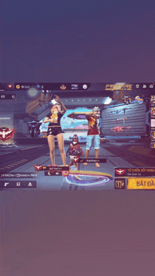 a man and a woman standing in front of a screen that says free fire on it