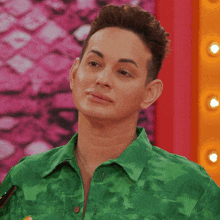 a man is wearing a green shirt with a snake print on it
