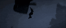 a man is flying through the air with a parachute