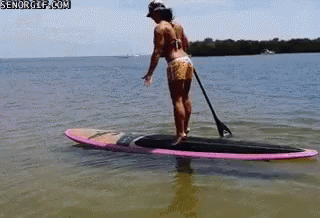 Woman falling off her paddleboard