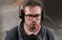 a man wearing glasses and headphones is talking into a microphone ..