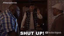 three men are standing in a room with the words shut up on the bottom