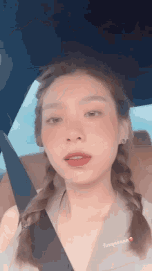 a woman is sitting in the back seat of a car with a seat belt on .