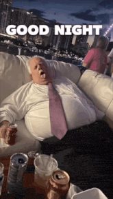 a man laying on a couch with a coca cola can in his hand