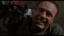 a man is putting his hand on a woman 's face in a movie scene .