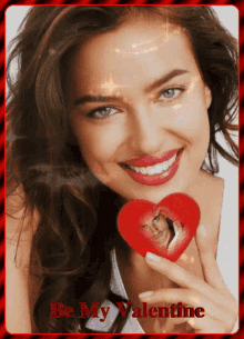 a woman holding a heart with a picture of a man in it and the words be my valentine