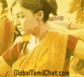 a woman in a yellow saree with the website globaltamilchat.com written below her