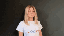 a woman wearing a white shirt that says skyz.cz on it