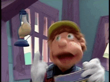 a cartoon character is holding a magazine and giving a thumbs up