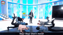 a group of people doing push ups on a stage with the words stay stay don 't move in the corner