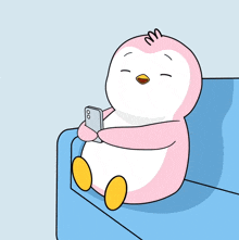 a cartoon penguin is sitting on a blue couch holding a cell phone