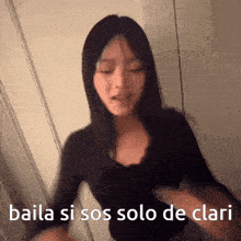 a woman dancing with the words baila si sos solo de clari
