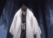 a man in a white kimono stands in a dark cave