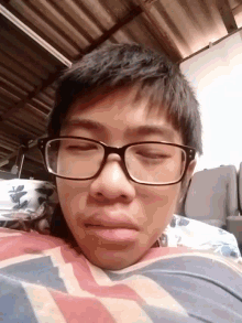 a man wearing glasses and a british flag shirt