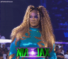 a woman in a wrestling ring with the name nia jax on the bottom