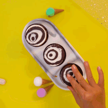 three cups of chocolate with a swirl on top