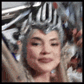a blurry picture of a woman wearing a silver crown