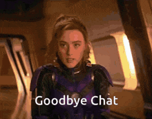 a woman in a purple suit is saying goodbye