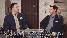 two men are sitting at a table with bottles of beer and the words stick your movie up your ass on the bottom