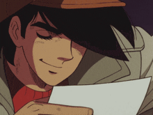 a man in a hat is holding a piece of paper and smiling