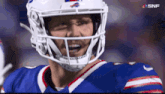 a close up of a football player wearing a helmet with snf written on the bottom