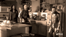 three men standing in a kitchen with a netflix logo on the bottom