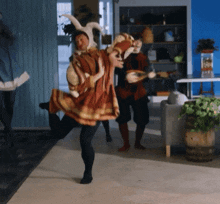 a man in a rabbit costume is dancing with another man