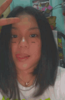 a girl with a tattoo on her face that says ' miss you '