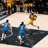 a basketball player with the number 5 on his jersey is running with the ball