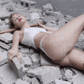 a woman laying on the ground with a hammer