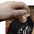 a hand is reaching out towards a man 's face .