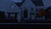 a white house with a black roof and a few windows