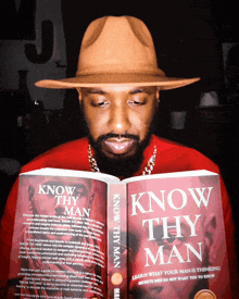 a man wearing a hat is reading a book called know thy man