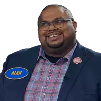 a man in a suit has a name tag that says alan on it