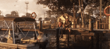 a man and woman sit on a dock next to a boat that says " predator "