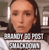 a woman is making a funny face with the words `` brandy go post smackdown '' written on her face .